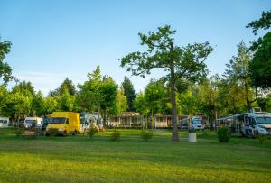 a group of rvs parked in a field at Lido Verbano Camping Village in Castelletto sopra Ticino +143 photos