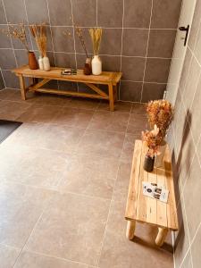 a bathroom with two benches and a tile floor at Studio Renard, style bohème et atypique, Curistes in Luxeuil-les-Bains