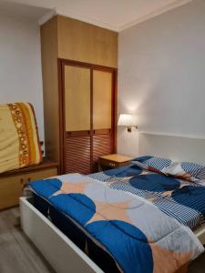 a bedroom with a large bed and a night stand at Copthorn Homestay in Brinchang