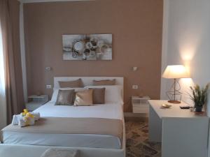 a bedroom with a large white bed and a table at Politeama Center in Palermo