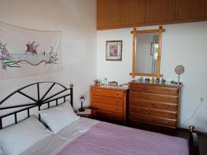 een slaapkamer met een bed en een dressoir bij Triopetra hill view in Triopetra