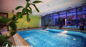 a large swimming pool in a large building at Grand Safir Hotel in Manama