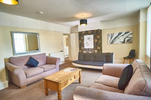a living room with two couches and a coffee table at No4 Apartment Birkdale Village in Southport