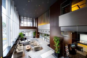 a lobby with a couch and tables and windows at Best Western Plus Fukuoka Tenjin-minami in Fukuoka