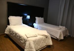 Ένα ή περισσότερα κρεβάτια σε δωμάτιο στο Ubay Hotel