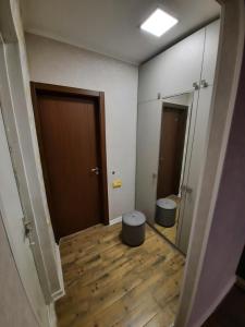 a hallway with a bathroom with a toilet and a door at Futuristic 1 Bedroom Apartment next to Vake Park in Tbilisi City