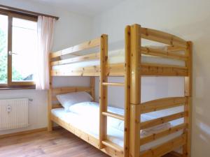 a bunk bed with a ladder in a room at Apartment Galaxie 218 by Interhome in Verbier