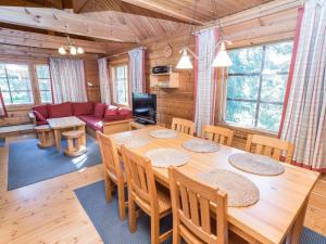 a dining room and living room with a table and chairs at Holiday Home Uolevintie 39a by Interhome in Ruka