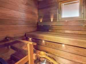 a small wooden sauna with a bench in it at Holiday Home Aurinkoranta by Interhome in Ruka +2 photos