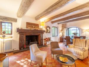 a living room filled with furniture and a fireplace at Holiday Home La Réalière by Interhome in Beaumettes