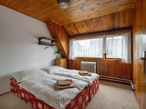 a bedroom with a bed with towels on it at Holiday Home Jestřebice 8 by Interhome in Dobřeň
