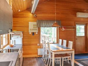 a kitchen and dining room with a table and chairs at Holiday Home Hyryn herra cottage by Interhome in Hyrynsalmi