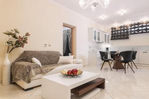 a living room with a couch and a table at Danae Luxury Apartment in Samos