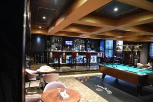 a pool table in a room with a bar at Grand Safir Hotel in Manama