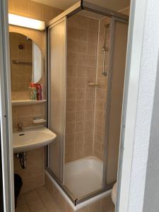 a bathroom with a shower and a sink at City Hotel Dinslaken in Dinslaken