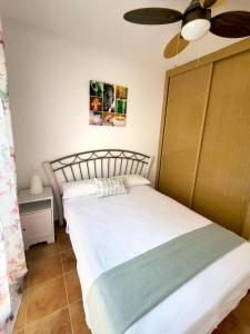 a bedroom with two beds and a ceiling fan at Casa en el valle del tietar in Lanzahita