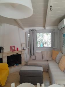 a living room with a couch and a table at Villa Menta in Lefkada Town