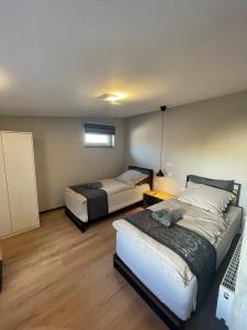 a bedroom with two beds and a window at L'Imeri Residence in Reilingen