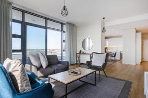a living room with a couch and a table at Axis Luxury Apartments by Century City Hotels in Cape Town