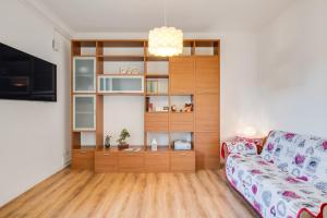 a living room with a couch and a book shelf at Corte Agordat Apartment x4 - Pet Friendly in Padova