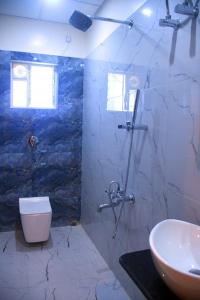 a bathroom with a toilet and a sink at PRINCE PALACE in Jhārgrām