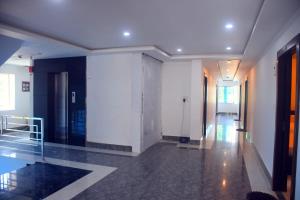 a hallway of a building with white walls at PRINCE PALACE in Jhārgrām