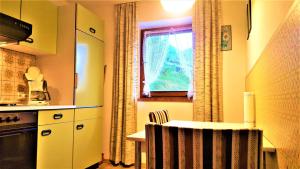 a kitchen with a small table and a window at 4 Bergpanorama mit herrlicher alpinen Almlandschaft Nichtraucherdomizil in Schönau am Königssee