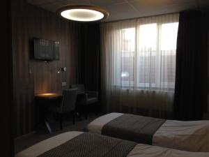 Letto o letti in una camera di Hotel Mille Colonnes