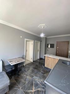 a living room with a table and a kitchen at dagkent plus suit in Tokat