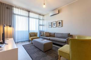 a living room with a couch and a chair at Axis Luxury Apartments by Century City Hotels in Cape Town +63 photos