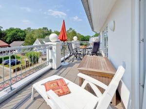 a balcony with white furniture and a table and chairs at Dünenresidenz Königin Augusta - Apt. 19 in Binz