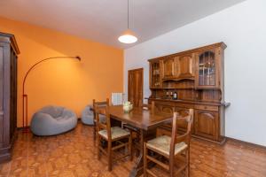 a dining room with a wooden table and chairs at CORTONA Piscina e Paradiso Verde Adults Only in Cortona