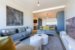 a living room with a couch and a table at Axis Luxury Apartments by Century City Hotels in Cape Town