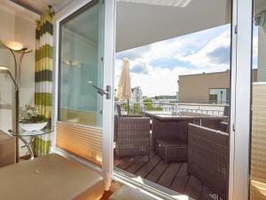 a balcony with a door open to a patio with a table at DünenResort Binz - Apt. 3.8 in Binz