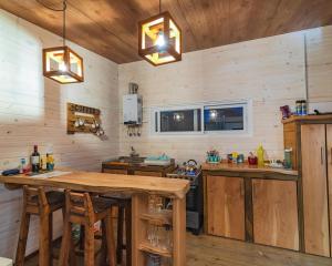 a kitchen with wooden walls and a wooden table at Villa Nora - Santa Isabel de La Pedrera in La Pedrera