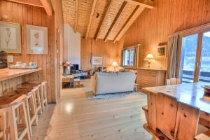 a large living room with wooden walls and wooden floors at Chalet Arnica in Fiesch