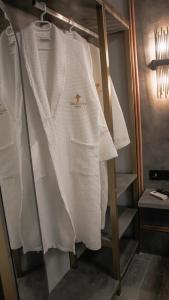 a white sweater is hanging on a rack at TALLES CITY HOTEL in Konak