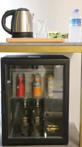a small microwave with several cans of beer in it at TALLES CITY HOTEL in Konak