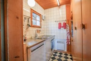 a small kitchen with a sink and a counter at Chalet Mungg in Bettmeralp