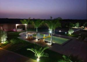 an overhead view of a swimming pool at night at RIAD - Jnan Bnati - Pool in Marrakech +46 photos