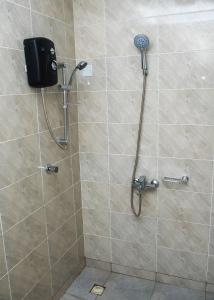 a shower with a shower head in a bathroom at William Ofori-Atta Fie in Accra