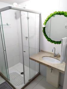 a bathroom with a shower and a sink at Apartamento JTR Maceió in Maceió