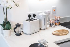 a kitchen counter with a toaster and other appliances on it at Birtin Works Apartments - Brand New - City Centre in Sheffield