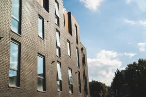 a tall brick building with windows on the side of it at Birtin Works Apartments - Brand New - City Centre in Sheffield