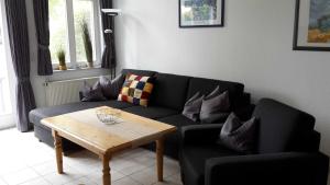 a living room with a couch and a coffee table at Landhaus am Haff_ Wohnung B 8 in Stolpe auf Usedom