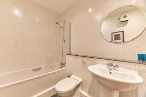 a bathroom with a sink and a toilet and a mirror at Low Friars - Properties Unique in Newcastle upon Tyne +40 photos