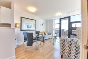 a dining room and living room with a table and chairs at Black Friars - Properties Unique in Newcastle upon Tyne