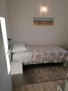 a small bedroom with a bed with at Apartment Nada 2 in Malinska