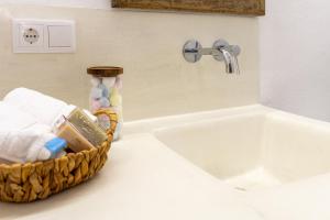 Un mostrador de baño con un lavabo y una cesta de toallas. en Casa Familiar en pleno Casco Antiguo de Altea, en Altea 32 fotos más