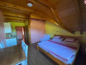 a bedroom with a bed and a table in a room at Penzion Major in Rokytnice nad Jizerou